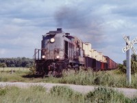 Lucky break to catch a hole in the cloud to brighten this view of CP 8459 at a country crossing on its way back to Woodstock from Tillsonburg.