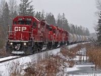An early snowfall is falling on the moraine as the Kawartha Lakes roadfreight heads east beginning it's decent of Maryanne's Hill. CP 3114, 3103, and 3057 provide the impetus. 1145hrs.