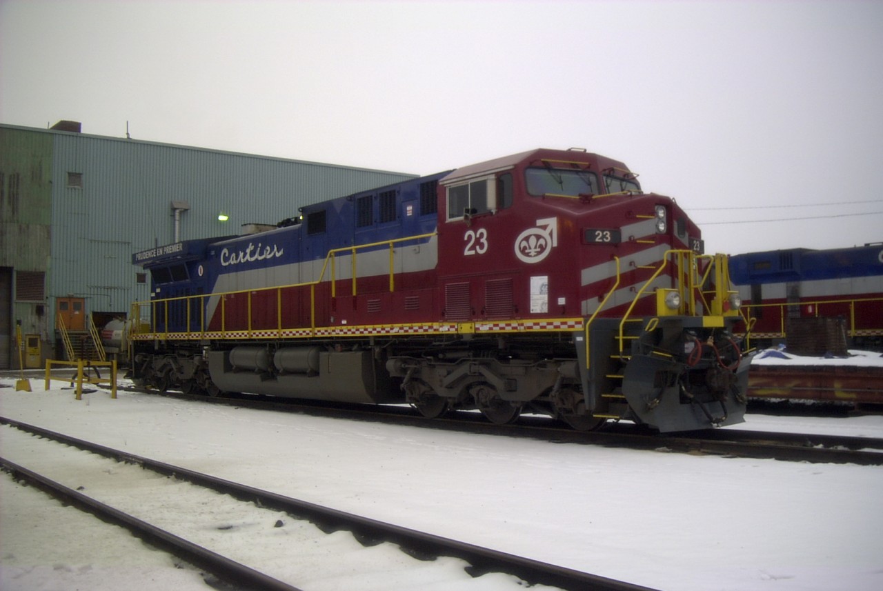 Cartier 23 stands on guard at the Port-Cartier locomotive shop on this dull and overcast November afternoon. While not new, the locomotive shows no signs of its hard use hsuling heavy ore trains.