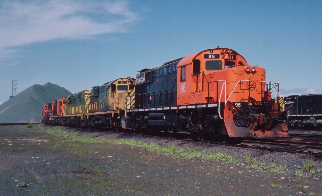 The whole fleet of RSD-15 Alcos on the Cartier roster! Seen are: 96, 91, 93, 92, 95 and 94 tucked back in on Iron Ore Mine property. Known to me as "alligators" due to their long snouts.