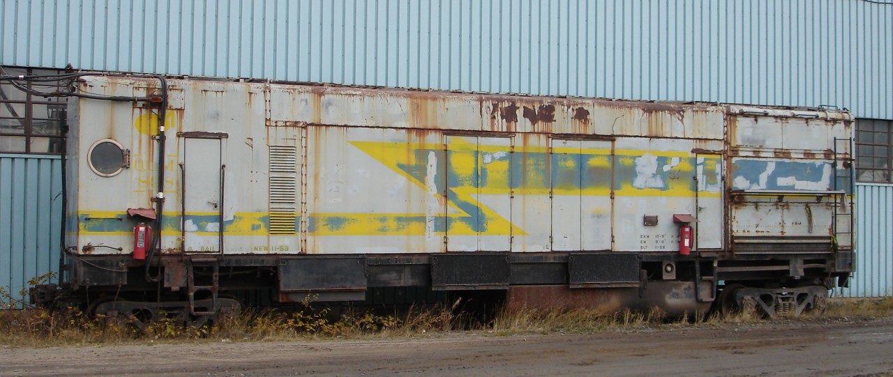 This un-numbered stationary generator car was sitting outside the car/locomotive shop tethered by a number of power cables to an out-building which housed Cartier's Cowen-Sheldon 150 ton wrecking crane No. C-4. The car was built new in 11/59. I do not know if it was purpose built as a generator or if it was modified by Cartier for the purpose.