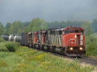 CN 450 - CN 5433 South with a days gone by lashup of SD50F # 5433, SD40-2's CN 5375, GTW 5933, and ONT 1733, approaching Washago on a wet and windy summer day in 2007. 