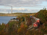 CP 8808 East snakes through the curves along Ramsey lake in the center of Sudbury, robot CP 9739 shoving on the tail end 2 miles of train away. 