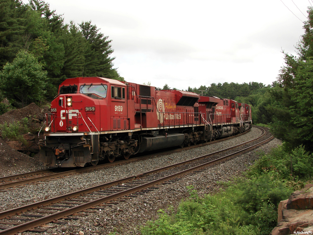 CN H222 - CP 9159 South (CP train 222-24) about to knock down a diverging to clear signal that will take them back over to the CP Parry Sound sub for the remaining 20 miles to MacTier for a crew change. Recently, all of CP's SD9043MAC locomotives were declared as surplus and put up for sale on CP's website, including CP 9159 who since being outshopped in 1999, has been "pulling for United Way", I guess United Way are now on their own!