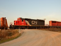 The CN/CP work train slowly passes over the Gleeson Line crossing where once stood one of the 2 remaining working sets of wigwags. The train is heading back to Chatham with a full load of rail to drop off and will pick up a waiting CP rail train to bring back down the CASO and continue removing the rail.