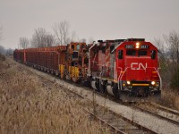 A cool gloomy morning sets the mood here. After just coming off of the Sarnia Spur and onto the CN CASO Sub, GTW 5937 & CP 6030 slowly pull the rail train to the first crossing west of Fargo where a CN foreman will watch it pass thru. The train will make its way to Essex today and start pulling track tomorrow as it heads back east towards Fargo.