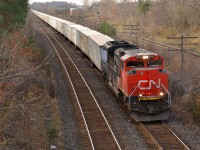 CN 144 led by solo 8015 approaches the Denfield Road bridge on its way into London