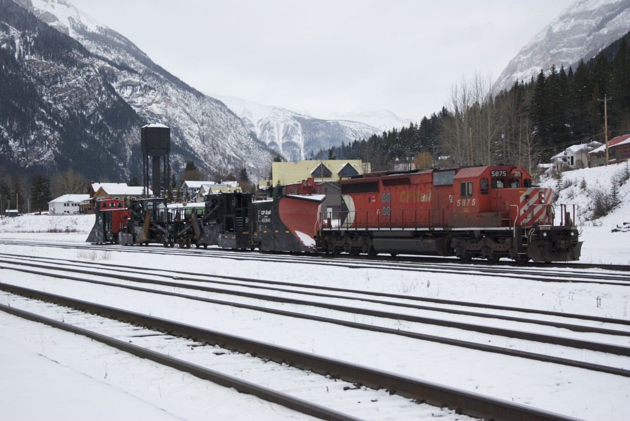 5875 sits with 2 sets of Snow Fighting Equipment at Field B.C captured November 14, 2012.  Wedge Plows and Jordan Spreaders ready to roll east or west with the first heavy snows.