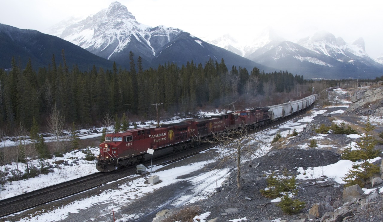 A manifest freight train with 8523 9702 & 9681 that had been "in the hole" at Gap for two westward trains, heads to Exshaw where it will do some work at the Cement Plants before continuing on to Calgary, November 18, 2012.