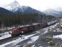 A manifest freight train with 8523 9702 & 9681 that had been "in the hole" at Gap for two westward trains, heads to Exshaw where it will do some work at the Cement Plants before continuing on to Calgary, November 18, 2012.