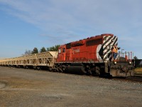 After spending the day dumping rock on the Nipigon Sub, CP 5759 West rolls into Thunder Bay with a friendly wave from the conductor. This spot known as Thunder Bay North in the timetable is more commonly refered to as the "Marina". In tow is one articulated train that is completely unique (as far as I am concerned). Doing some research it is owned by the Georgetown Rail Equipment Co. (GREX) and this train is known as "the Dump Train". The train made up of 15 (white) "hopper" cars -all as one set- with a blue "transfer car" on the tailend. The cars dump their loads onto a conveyor system that runs the length of the train and the "Transfer car" will sling the ballast where it needs to go. 

Georgetown Rail Equipment Co. is an outfit out of Texas that claims this equipment can unload 2,000 tons per hour!