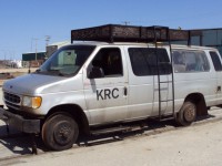 While on a trip to commission a new Knox Kershaw KBR925 ballast regulator for KRC, NAES (Canada) Ltd. Sales Manager David Wylie came across this Keewatin Railway Company Ford van. Certainly not your average hi-rail vehicle found on most railways, this one is steel-wheeled and railbound. The maintenance vehicle is equipped with a turntable allowing the crew to reverse direction of the truck so they do not have to travel backwards for any great distances. Note it is connected to a heavy duty 'push car' for transporting track material and/or small power tools. (Photo by David Wylie used with permission).The Keewatin Railway Company (KRC) is a First Nations-owned rail line that operates in Northern Manitoba, between The Pas, and Pukatawagan. The railway company owns the line from Sherritt Junction (interchange with Hudson Bay) to Lynn Lake, about 185 miles (310 km). It currently operates mixed (passenger and freight) services from The Pas to Putakawagan, about 156 miles (251 km), of which 58 miles (93 km) is on the tracks of Hudson Bay Railway KRC started operations on April 1, 2006. The passenger service, formerly operated by VIA Rail Canada, continues under a new operating agreement between Keewatin Railway Company and Via Rail Canada. KRC operates two round trips between Pukatawagan and The Pas each week. Trains carry passengers and freight for the community of Pukatawagan.