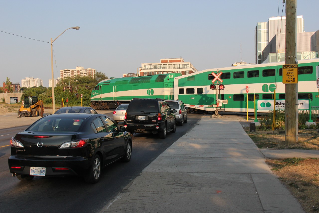 The second of the two westbound GO trains from Toronto eases across King Street into the track where the train sits until its next departure to Toronto.