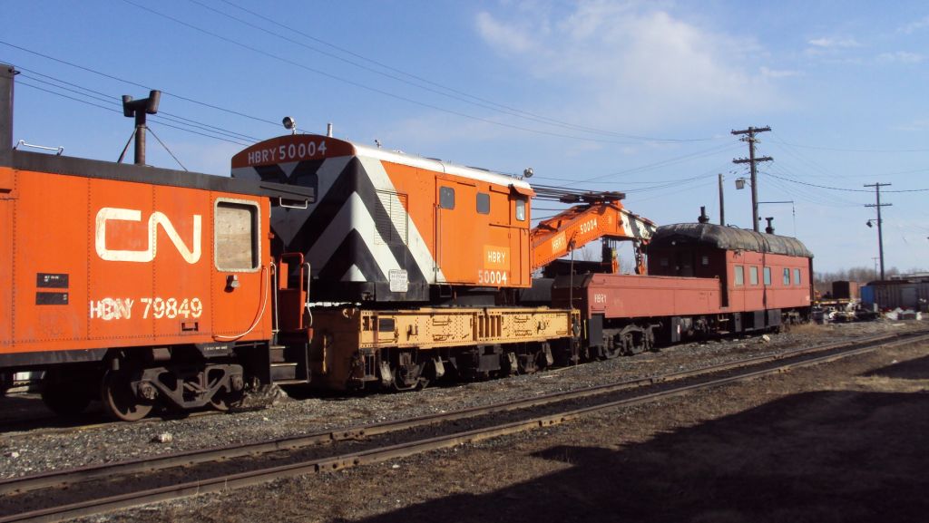 This alternate view of the HBRY classic wreck train gives a better indication of the equipment condition. The boarded up window openings in the van, and the slight sway in the boom idler/coach are tell-tale signs of age and neglect. The Industrial Works s/n 4408 160 ton crane built in 1924 appears to be in the best condition of all three pieces of equipment.