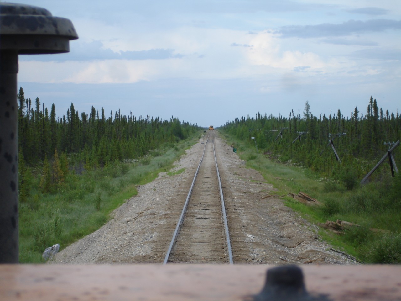 In this view from the cab of a piece of MOW equipment, HBRY's 30 m.p.h. main line to Churchill, MB is looking pretty good after a tie gang has rolled through and done its job.  The lack of ballast, the tripod pole line, and the dwarfed landscape are very characteristic of this portion of the line. Make sure you packed a lunch because its a long way to anywhere from here! David Wylie photo submitted with permission.