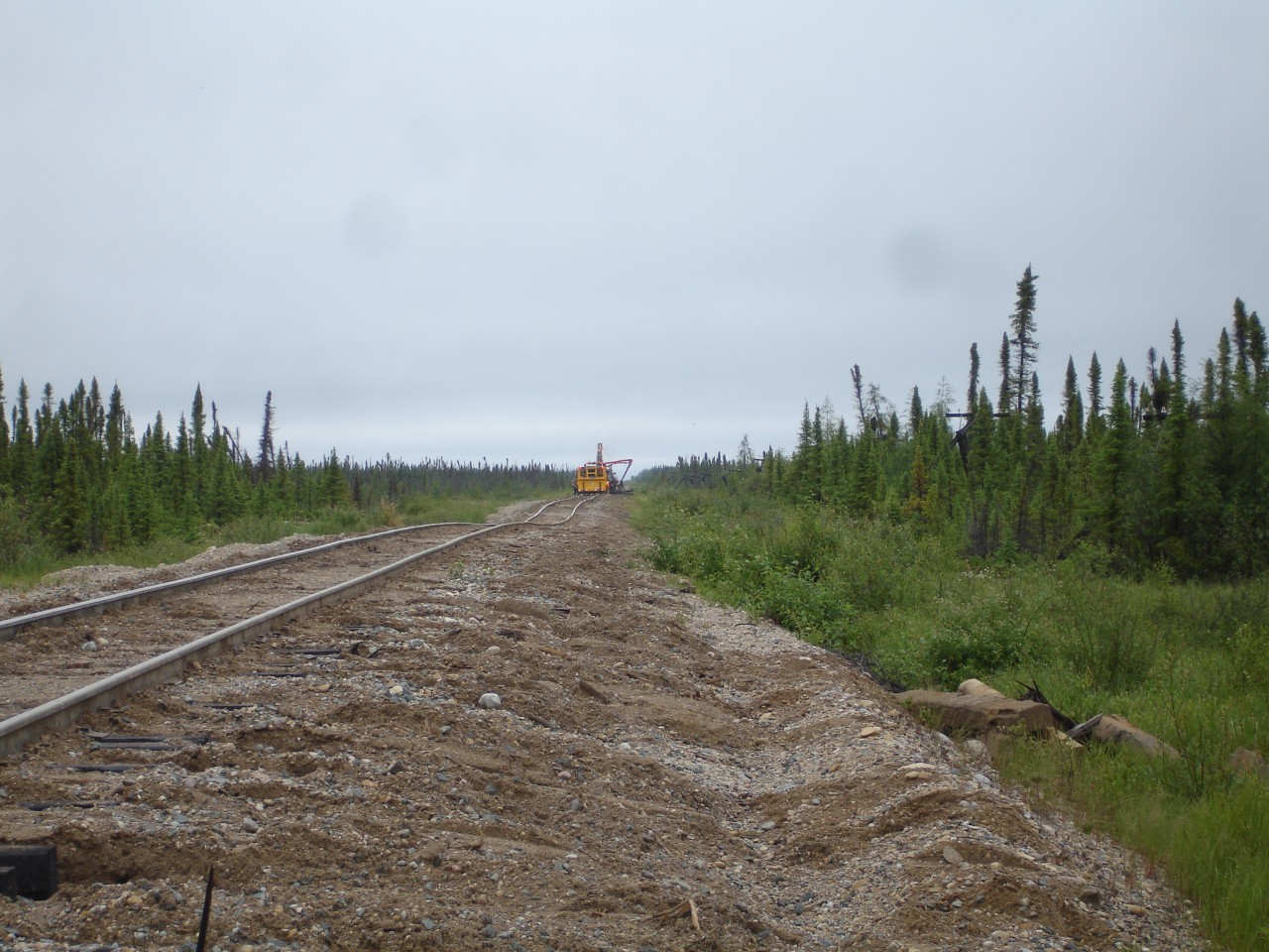 North of Gillam, between Amery and Charlebois, MB, the Hudson Bay Railway main line is not quite as pretty as your normal track structure.  In this pic, crews are working hard to replace ties and tamp track to provide a safer and more comfortable ride for both passengers and cargo alike. The only way in or out of this portion of the line is by rail.  The roads stop just outside of Gillam. The vegetation continues to get shorter, thinner, and more sparse as you get closer to Churchill.  Photo by David Wylie submitted with permission.