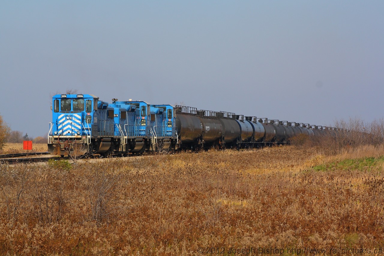 CEFX 2006 and two other sister units are sitting in the SOR yard at Garnet Ontario.  The red flag at the front of the locomotive is there to protect a work crew that was the main switch into the yard at Garnet.