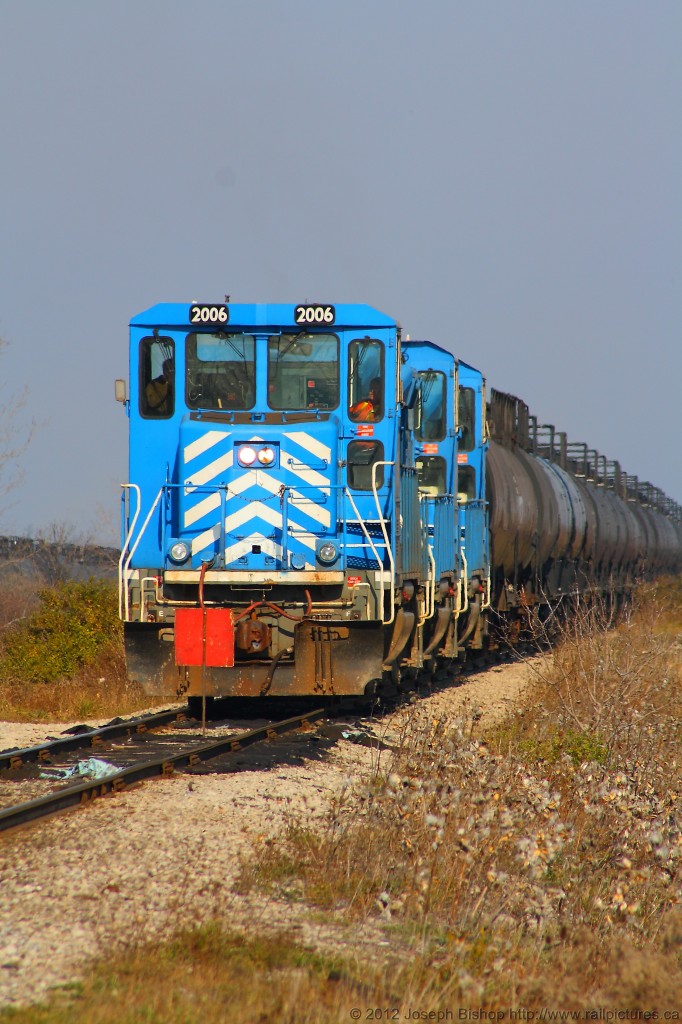 SOR 598 awaits the removal of a restricting flag that is not allowing the crew to get to work in the yard sorting out the cut of cars from that nights work in Paris and Brantford.  They returned with so many cars that they had to split their train in two in order to not block a crossing.