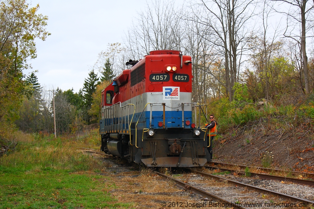 The conductor on RLK 4057 looks back at me as he rides the rear of his locomotive.  He will have to throw the switch up ahead to run his locomotive back up the wye to collect his train.
