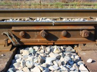 Pictured is a joint bar on the CN Hagersville Subdivision.  Every day the SOR runs two trains across this track.  Their main commodity is fuel from the ESSO plant in Nanticoke and steel from the US Steel works also in Nanticoke.  A joint bar holds together two pieces of track with four bolts in total.  What is cool about a joint bar in this shot is that all the bolts are not facing the same way.  This is done so that when a derailment occurs there is less of a chance of having the track seperate and made the derailment more severe.  The joint bar in the photo was manufactured in 1947 and has seen many changes to this line over the last 65 years and will probably be around to see many more years of change.