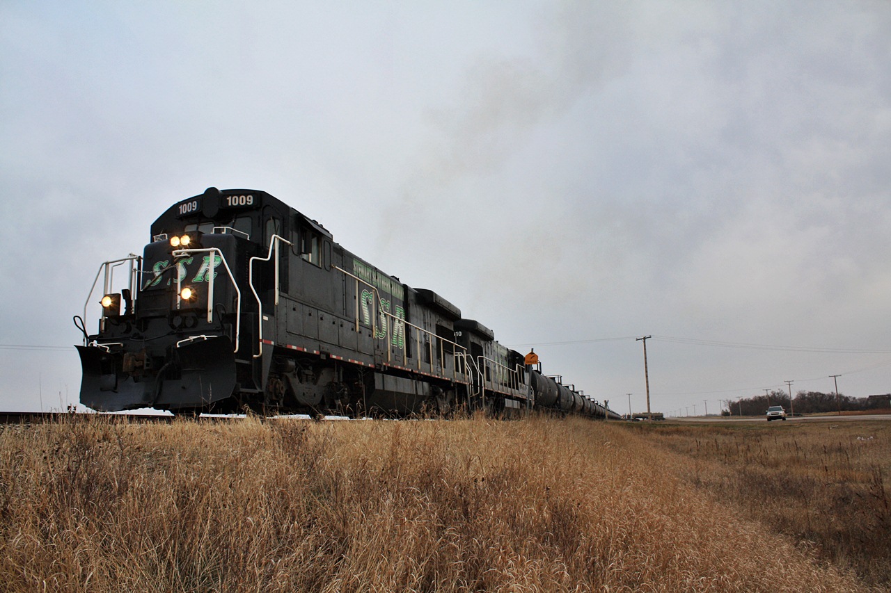 Stewart Southern Railway has become one of the companies to watch in Saskatchewan for there innovative oil train, if one was to drive down this line early in the CP days between 2000 and the time that they sold the Tyvan Sub to SSR one would rarely find a single hopper along the line. Oddly enough you may find yourself finding the same thing driving along the highway from Regina to Stoughton as it has become solid oil cars parked at once busy grain elevator sidings. Today Stewart Southern and there fleet of 6 units (3 B23-7'S and GP15D'S) have been busy with there recent business at Stoughton which has quickly become one of the oil hubs in the bakken oil field territory. As of recently a friend and former co-worker at Cando now with Ironhorse Rail Service has helped build a two track 50 car spot specifically for oil because Blair Stewart the owner of Stewart Southern has simply ran out of capacity. Thanks to the economic boom making Saskatchewan one of the richest provinces in Canada this 89 mile long piece of tangent track which is one of the longest in Canada without any curves has stayed alive and continues to surprise folks.