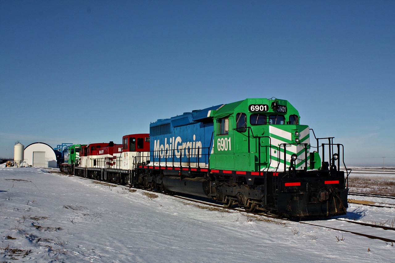 A 5 unit lashup consisting of two SD40-3's and three GE 70-Ton units sit parked at Aylesbury Sk, after a snowfall hit the area.