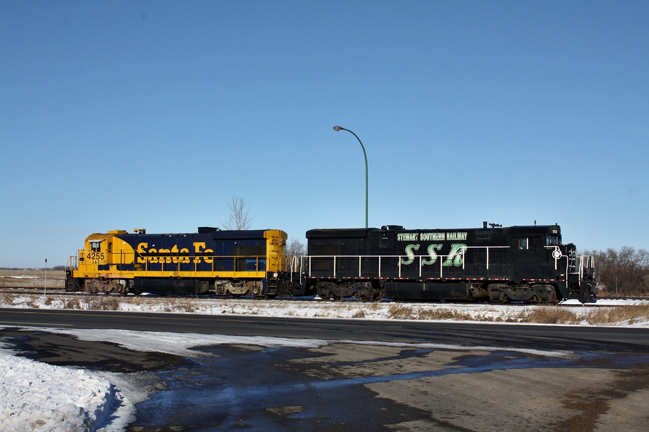 Two B23-7's of Southern and ATSF heritage roll by Fillmore lite after dropping of tankers at Francis for storage until needed. After chatting with the hogger who was a former CP Locomotive Engineer out of Regina and asking him if he ever thought the Tyvan Subdivision would end up to be such a gold mine he joked by saying last time the line saw this much traffic the Toronto Maple Leafs won the Stanley Cup.