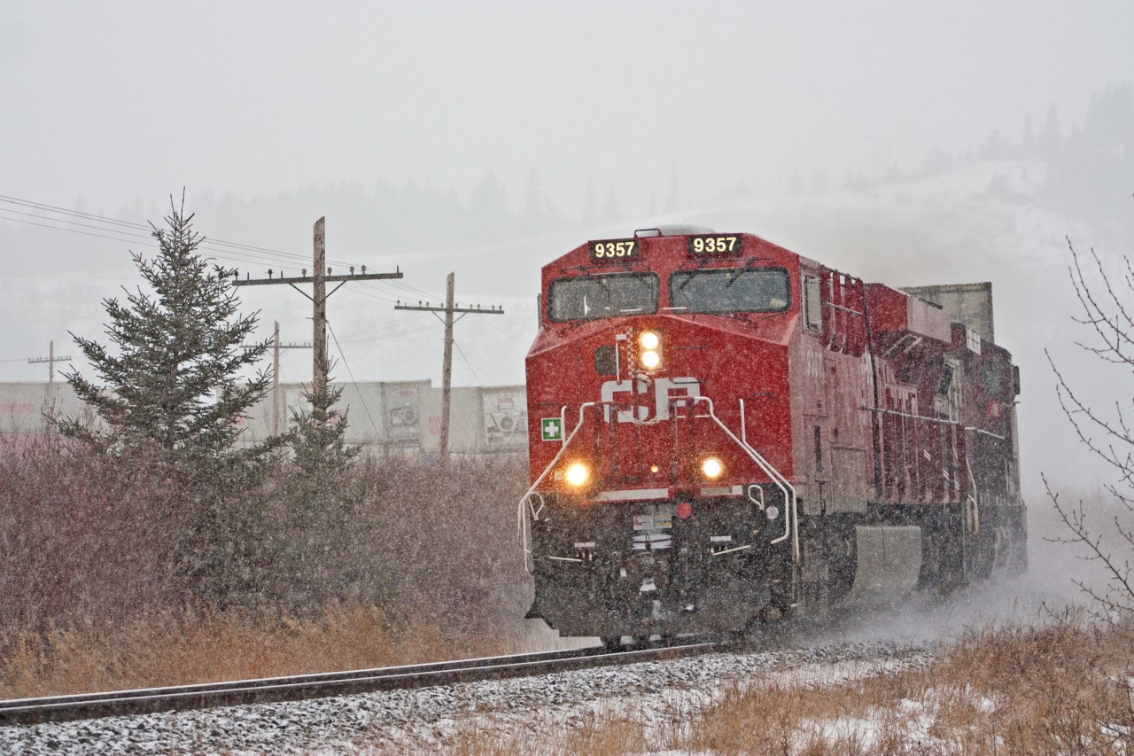 Dusting up the little snow that is falling, CP 9357 is rounding the curve just east of Gap Lake on it's way towards Calgary.