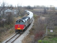 The CFL Centennial Train backs down the Point Edward spur on the way back to CN's Sarnia yard. While VIA trains regularly used the first part of the Point Edward Spur as a lead to cross over the main and access the wye, this is the first time in decades, if not even a century, that any passenger train has come this far. No passenger train will have ever been shot on this curve from this bridge before, and likely never will be again.