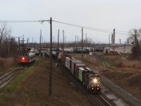 While the CFL Centennial Train waits for its signal to cross over the main to access the wye while CN 501 lead by BCOL C44-9W 4653 rolls down the hill to the tunnel.