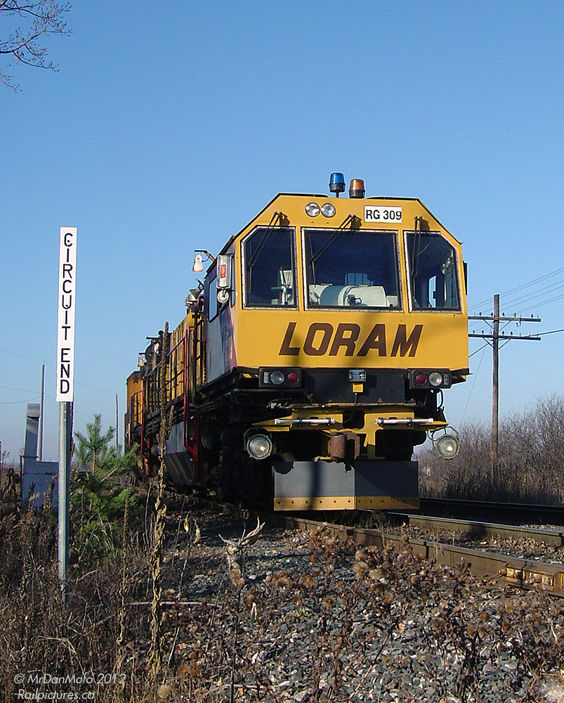 The LORAM Railgrinder sits on the siding at Kleinburg at the circuit end sign, awaiting a meet between CP #101 (northbound) and #222 (southbound) before grinding south on the MacTier Subdivision.