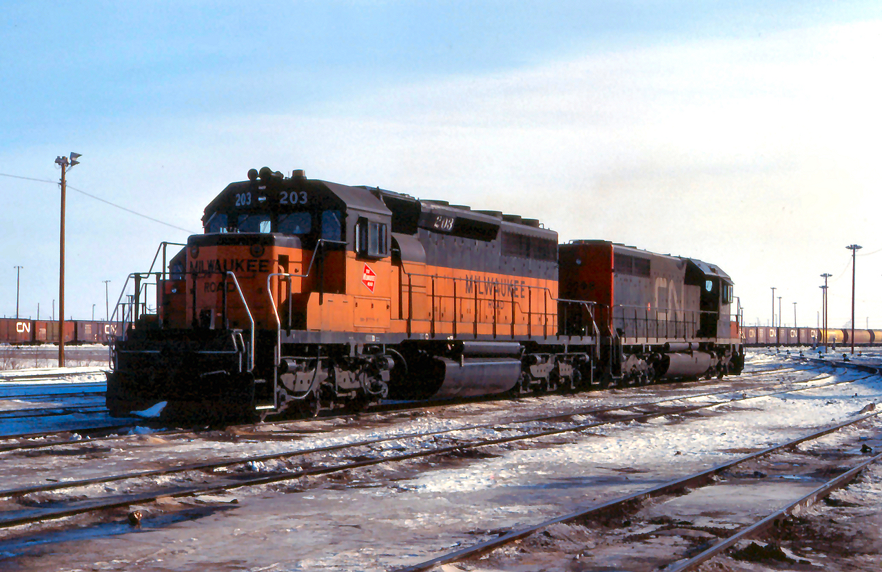 Leased Milwaukee Road SD40-2 # 203 idles at Symington Yard paired up with CN SD40 # 5208
