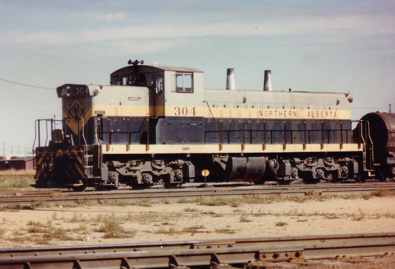 Avisit to NAR's Dunvegan Yard (Mile 0.7 Edmonton Sub.)resulted in only seeing this branchline switcher, GMD1 #304 idling out in mid-yard as the crew probably had stopped for lunch. Despite the tough sun angle and all, in retrospect it was a good catch.
 NAR, which was jointly owned by CN and CP, in 1981 became under the blanket of CN after they bought out CP's share. NAR #304 became CN #1081.  The NAR Shop and yard were demolished soon after the takeover.
 And the NAR became another chapter in the history books.