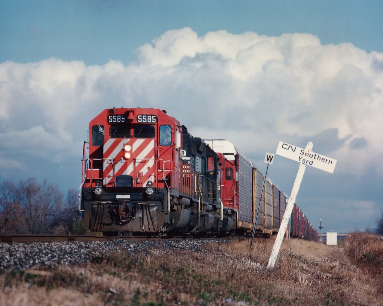 Daily NS autoparts train, Talbotville to Buffalo train #328 with CP5585,NS3279 and CP 5657 passes CN Southern Yard, mile 17,Stamford sub., under menacing Lake Ontario clouds.