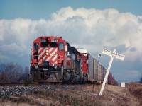 Daily NS autoparts train, Talbotville to Buffalo train #328 with CP5585,NS3279 and CP 5657 passes CN Southern Yard, mile 17,Stamford sub., under menacing Lake Ontario clouds.