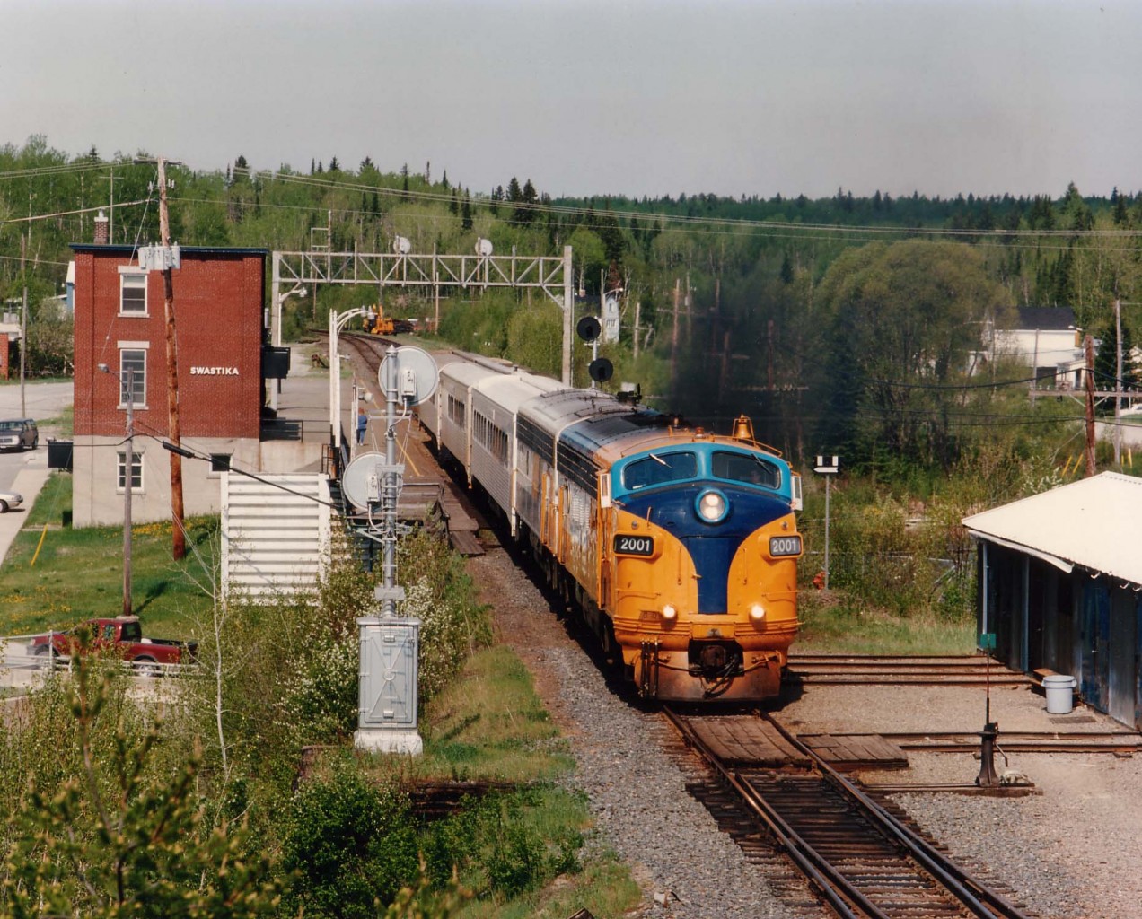 Mid-morning southbound ONR #122 with 2001,205 for power accelerates out of Swaskita, Ont. The leader is the former 1509 and was retired 2004, scrapped 2008.