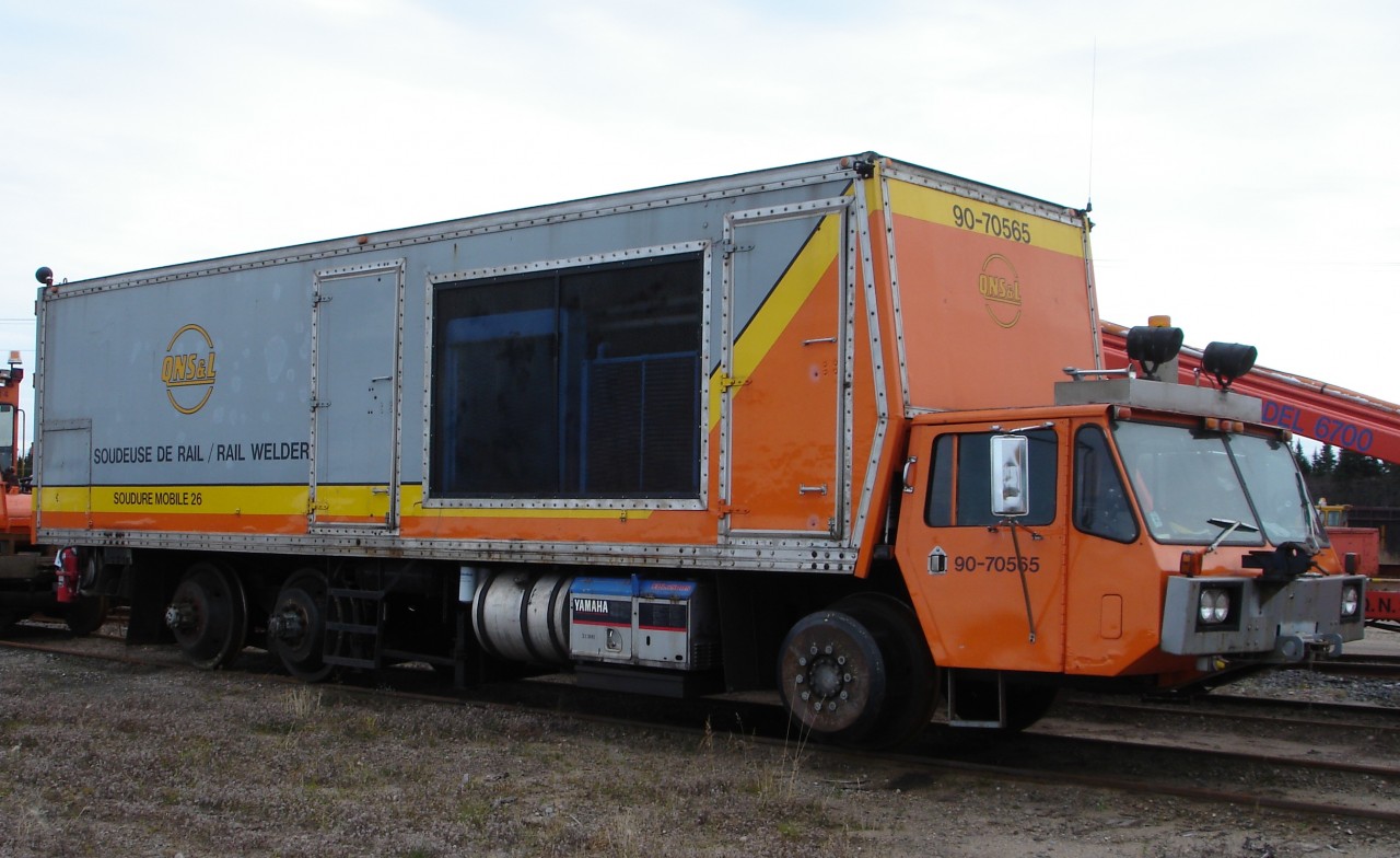 The relentless pounding of massive locomotives and heavy ore cars demands as few bolted rail joints as possible. When laying new CWR, repairing broken rails, or eliminating bolted rail joints, this mobile flash-butt welder can quickly and economically join two rail ends together in-track to form a seamless string of steel. QNS&L's colourful paint scheme looks great on this piece of high-tech equipment.