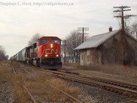 CN 434 (Windsor to Toronto manifest) is passing Comber Station with about 50 cars in tow. Comber Station is arguably one of, if not the oldest Wooden Railway stations in Canada still in railway service - built in 1871. At the time this caption was written, the last train on the CASO is on the line and this section of track will soon be a part of history.