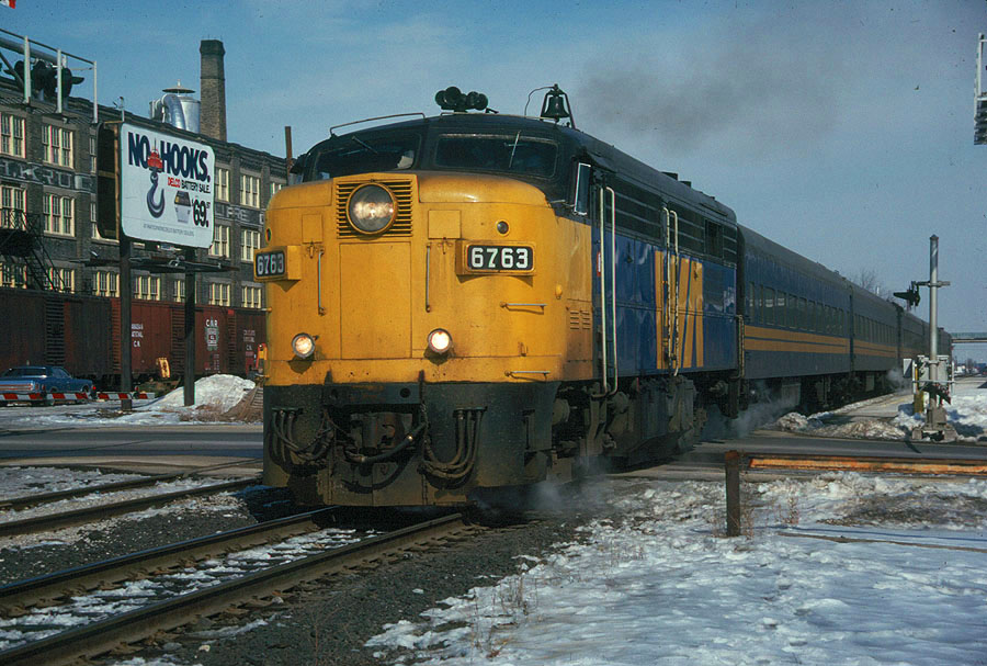 VIA FPA4 6763 departs from a ststion stop at Kitchener, Ontario with VIA train 83 in tow.