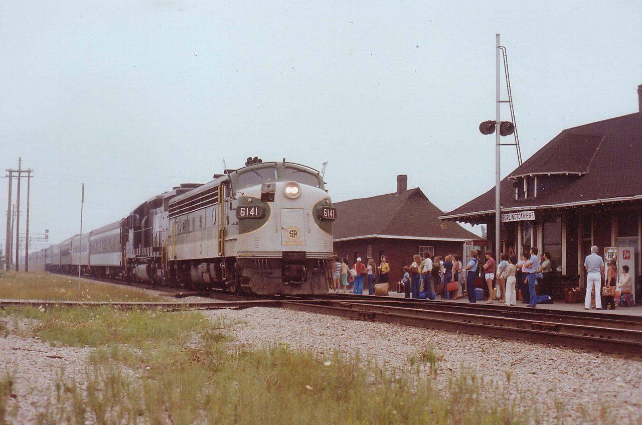 Here's proof that indeed once upon a time a Southern FP7 powered a passenger train by the former Freeman, Ont., station now Burlington West.
 Unfortunately my notes regarding this run are lost, but it was apparently a US special bringing Suits to some gathering in Toronto. Would be nice if someone could shed some light on this.
 In this view, on a miserable overcast July afternoon, SOU 6141 and N&W 1518 power a long train of mixed heritage coaches back toward the US by way of Niagara. By the time the train reached Grimsby, the sky was so dark slide photography was impossible.
 The crowd at the station are taking little interest in this Special. I believe they were waiting for #85, the "St. Clair", which was soon to follow.
Note foreground "rail" for moving Trackcars off the main. More history gone.