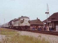  Here's proof that indeed once upon a time a Southern FP7 powered a passenger train by the former Freeman, Ont., station now Burlington West. Unfortunately my notes regarding this run are lost, but it was apparently a US special bringing Suits to some gathering in Toronto. Would be nice if someone could shed some light on this. In this view, on a miserable overcast July afternoon, SOU 6141 and N&W 1518 power a long train of mixed heritage coaches back toward the US by way of Niagara. By the time the train reached Grimsby, the sky was so dark slide photography was impossible. The crowd at the station are taking little interest in this Special. I believe they were waiting for #85, the "St. Clair", which was soon to follow.Note foreground "rail" for moving Trackcars off the main. More history gone.