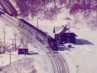   On a bright but cold sunny day CN 3105 with 4 cars & a steam jenny pulls away eastbound from the old Dundas station after its' scheduled 10:27 stop.  Station suffered a stove fire in 1986 and was demolished the following year.