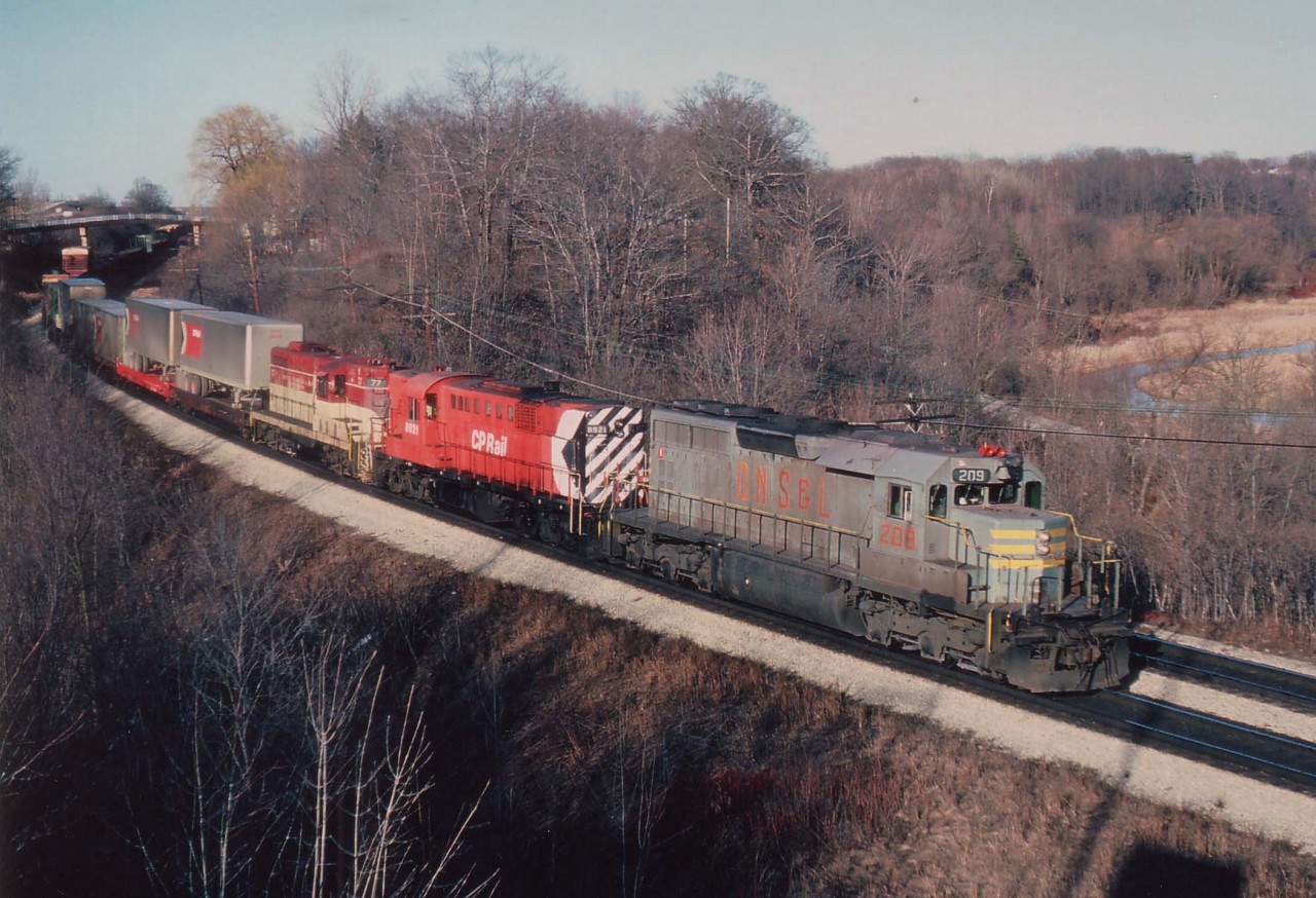 Quite the combination of power on this afternoon's TH&B "Starlite" with QNSL 209, CP 8921 and TH&B 77 seen here on approach to Bayview Jct. The Starlite was a daily late afternoon/early evening run between Toronto and Hamilton (and return) over the CN, and was a favourite of the railfan crowd.