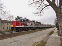 The VIA CFL Special backs through Downtown Guelph. The train features a specially wrapped consist with murals of CFL players to celebrate the 100th Grey Cup as well as a museum in the interior of the cars including the Grey Cup itself. Tours are scheduled across Canada in partnership with Rona.