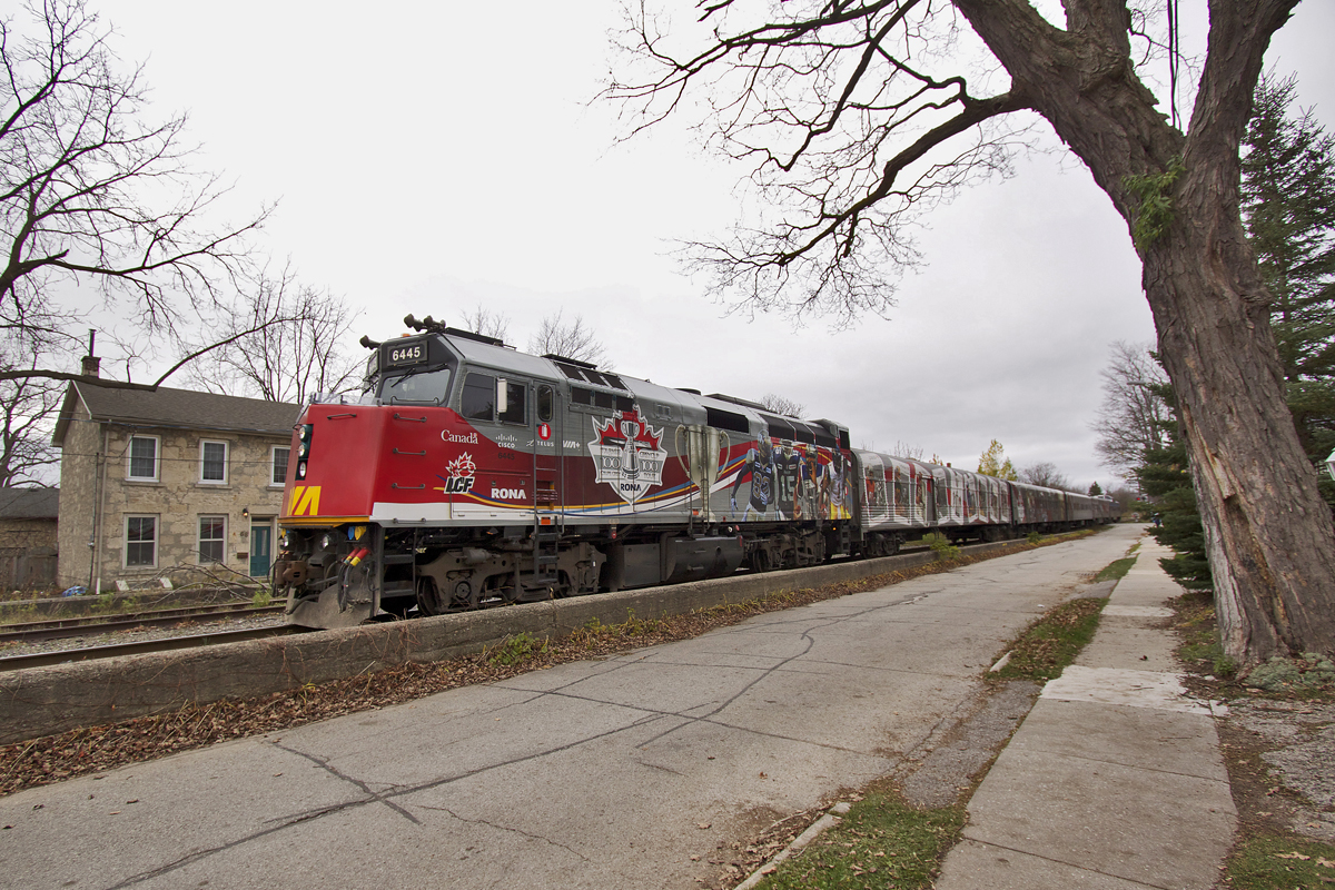 The VIA CFL Special backs through Downtown Guelph. The train features a specially wrapped consist with murals of CFL players to celebrate the 100th Grey Cup as well as a museum in the interior of the cars including the Grey Cup itself. Tours are scheduled across Canada in partnership with Rona.