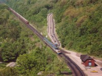 CN westbound with CN 5031, 2317, 4577 (with Int'l van) is off in the distance as morning VIA #70 with BBD LRC-2 #6904 approaches Dundas Station, at mile 4.7 on the Dundas Sub.  Station caught fire @ 1986 and subsequently torn down.