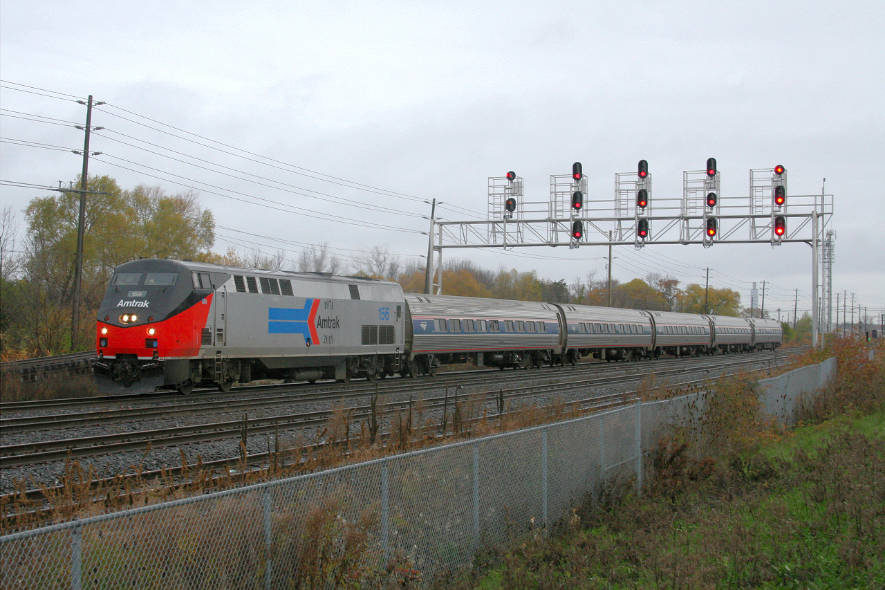 Amtrak 156 sporting the Phase I heritage paint scheme eases through Oakville on a dreary November morning