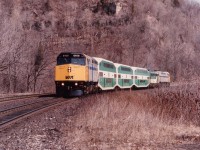 
VIA having major problems with metal fatigue in their LRC car axles in the spring of 1992 resulted in some unusual passenger lashups. A broken axle on March 17th was the fourth such incident recently and resulted in all LRC coaches being removed for service and axles replaced. Pressed into service as replacements were some CP stainless steel cars, some CN blue and some GO bi-levels.  On this particular day train #73, rolling west at Dundas approaching mile 5 has VIA 6408, three GO bi's, GO 907 (perhaps as a steam jenny unit) and VIA 6446 trailing.
The LRC cars were all refitted with new axles and back into service by June/92.