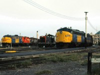 VIA #2 The Canadian led by VIA 1410 and VIA #4 The Super Continental led by 6536, bracket CN 7162 as they make their station stop at Winnipeg in 1981.