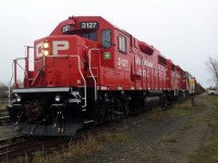 Fresh from the paint shops, 3127 and her sister pull this CWR train into Havelock, Ontario.